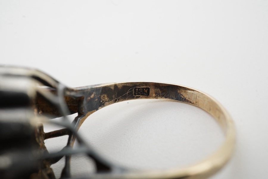 An Indian? yellow and white metal (shank stamped 18k), greyish star sapphire and simulated diamond cluster set dress ring, size O, gross weight 8.2 grams. Condition - poor (stone missing).